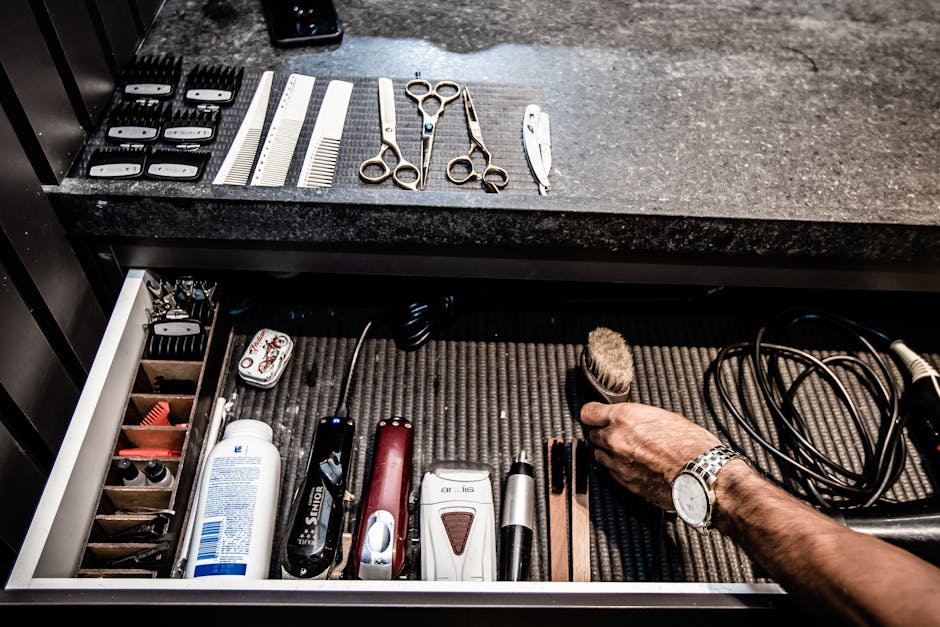 A neatly organized drawer featuring various barber tools and accessories at a barbershop.