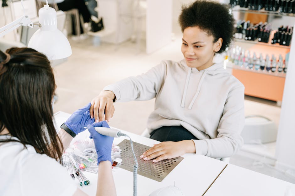 A woman enjoys a professional manicure at a modern salon, focusing on beauty and self-care.