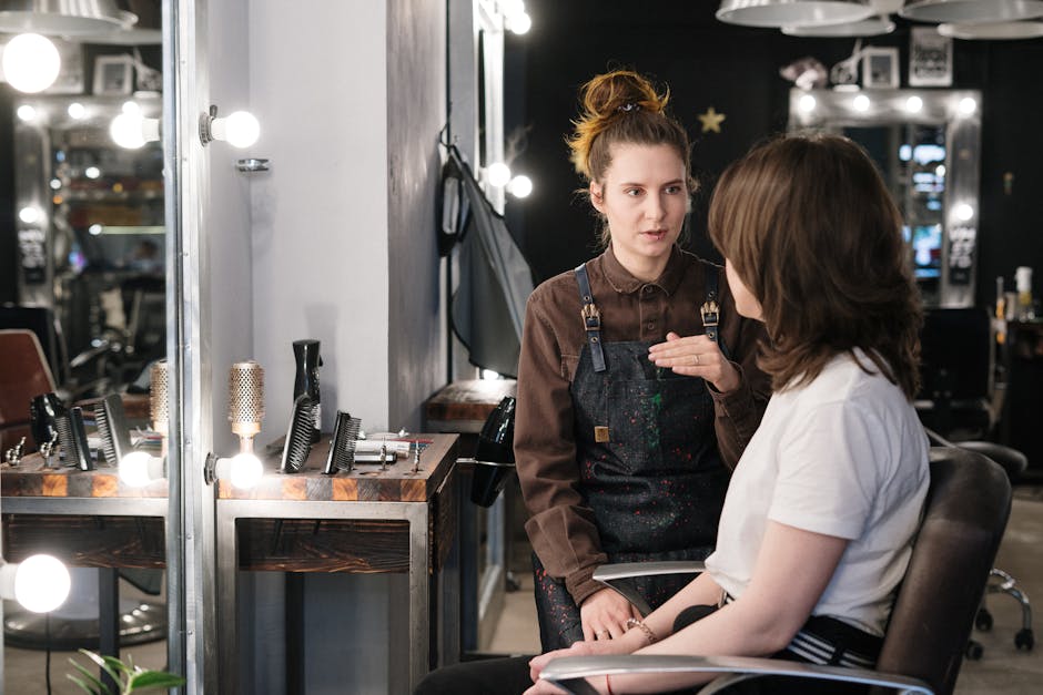 Hair stylist providing consultation to client in a modern salon setting.