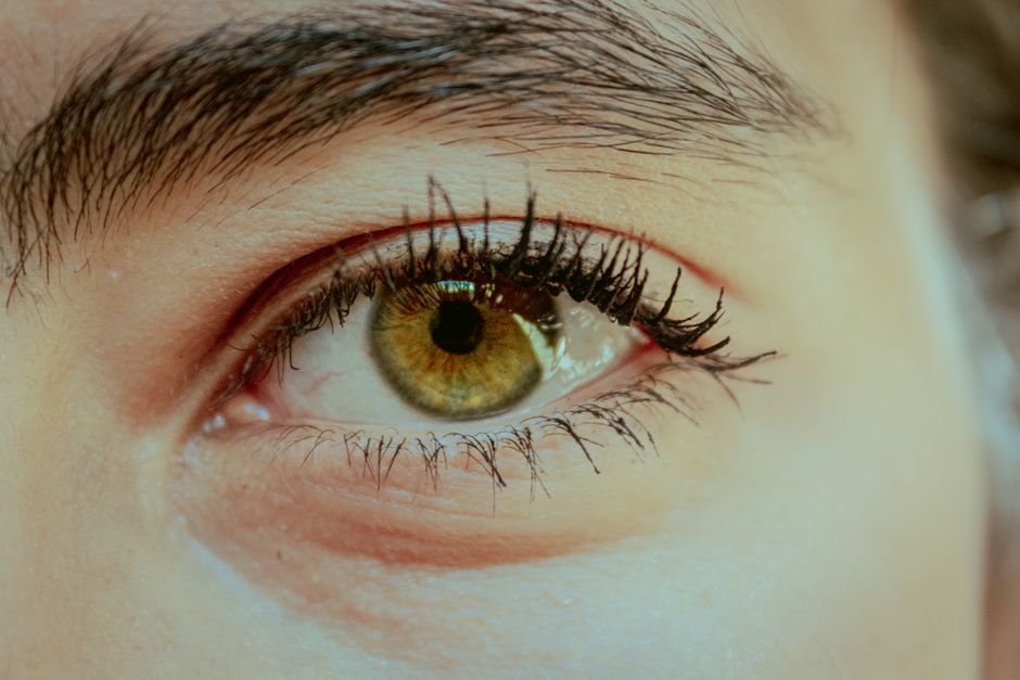 Detailed image of a human eye focusing on the iris and eyelashes.