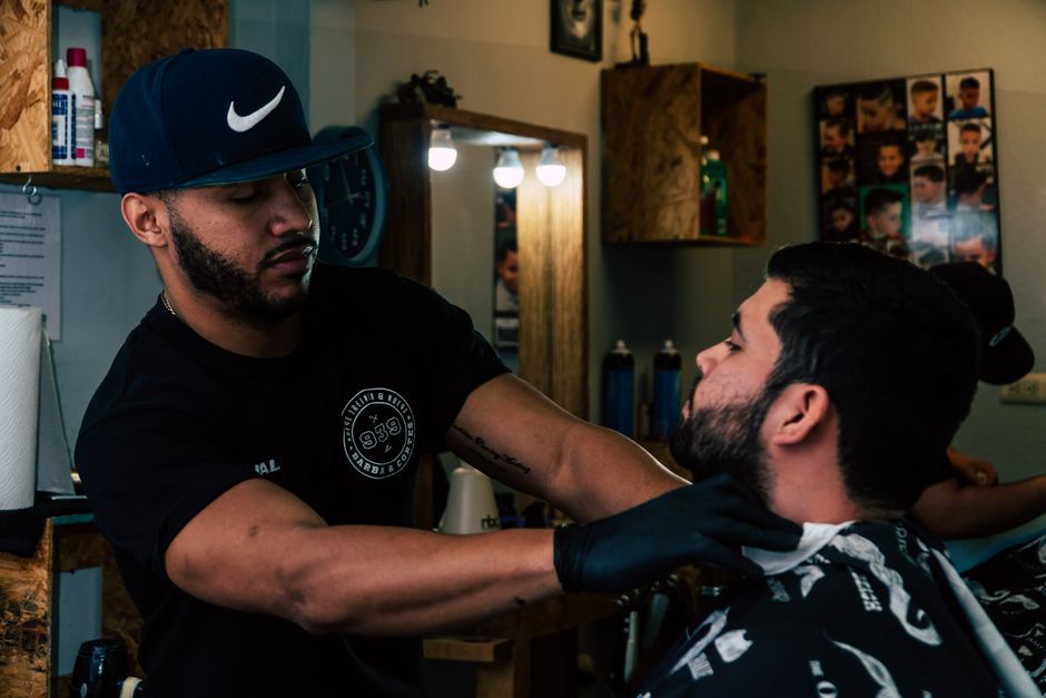 Barber skillfully trims a man's hair in a modern barbershop setting.