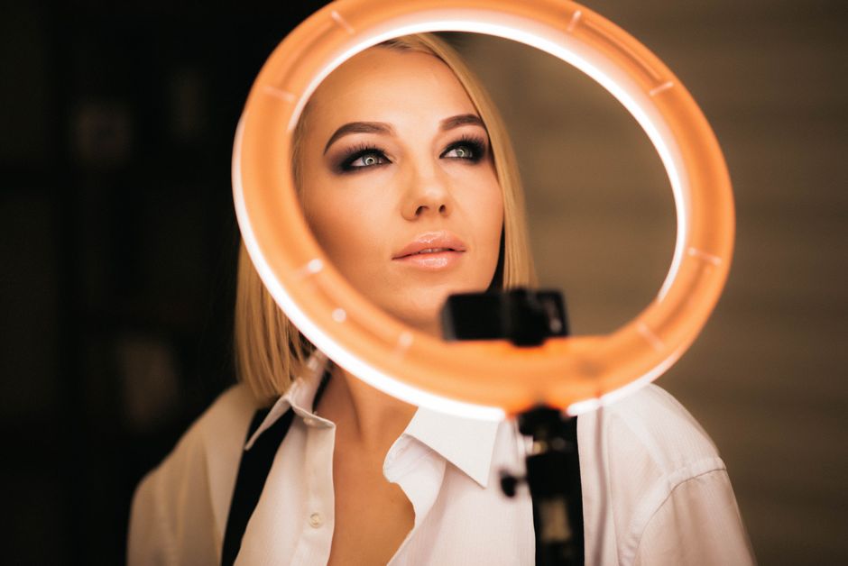 Captivating studio portrait of a fashionable young woman illuminated by a ring light.